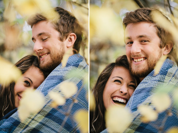 engagement session in the woods, surrounding a fire with smores and flannel in autumn