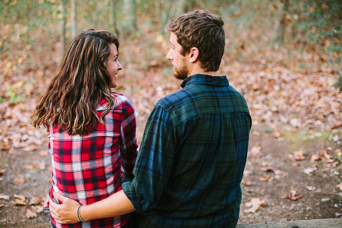 engagement session in the woods, surrounding a fire with smores and flannel in autumn