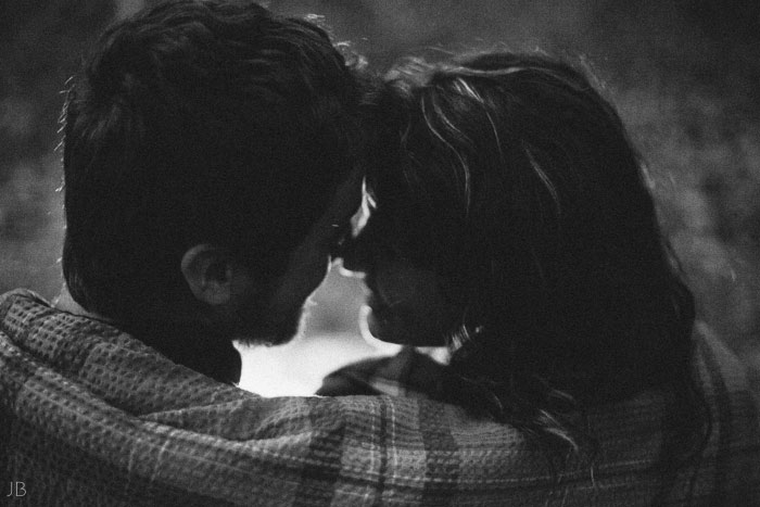 engagement session in the woods, surrounding a fire with smores and flannel in autumn