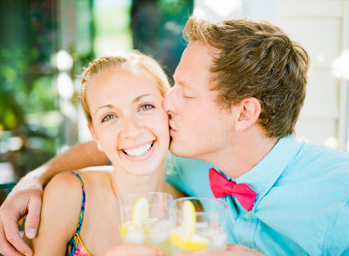 enjoying lemonade on porch under a vine summer engagement session shot on Fuji 400H