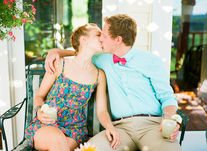 enjoying lemonade on porch under a vine summer engagement session shot on Fuji 400H