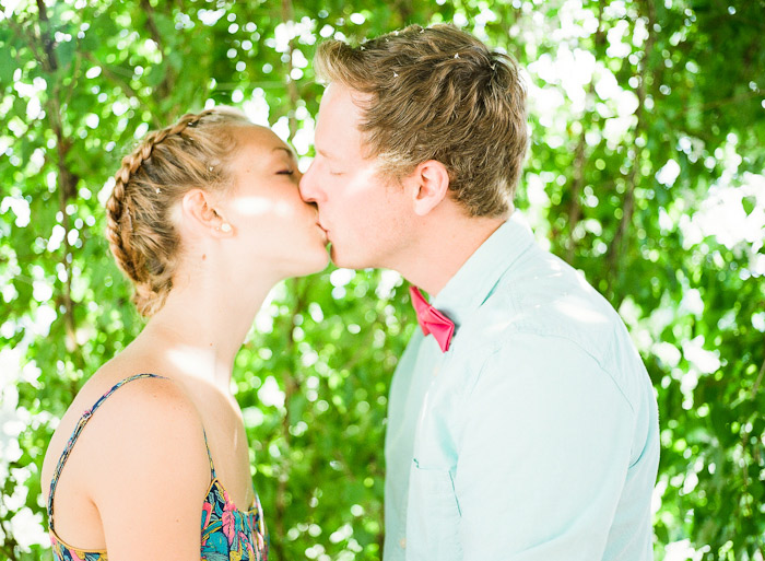 enjoying lemonade on porch under a vine summer engagement session shot on Fuji 400H