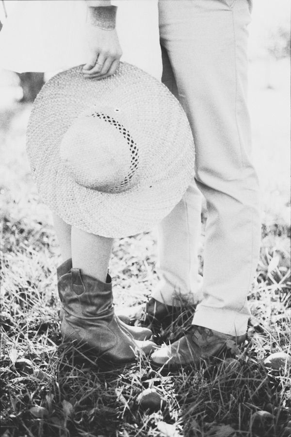 dreamy vintage engagement in an orchard kiss behind vintage straw hat camera color film fuji400h medium format vibrant