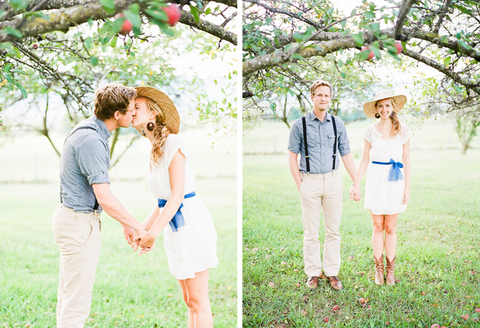 dreamy vintage engagement in an orchard kiss behind vintage straw hat camera color film fuji400h medium format vibrant