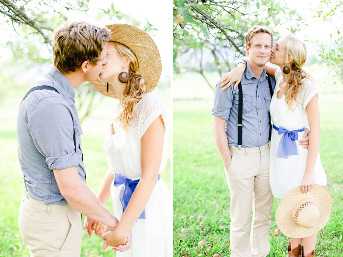 dreamy vintage engagement in an orchard kiss behind vintage straw hat camera color film fuji400h medium format vibrant