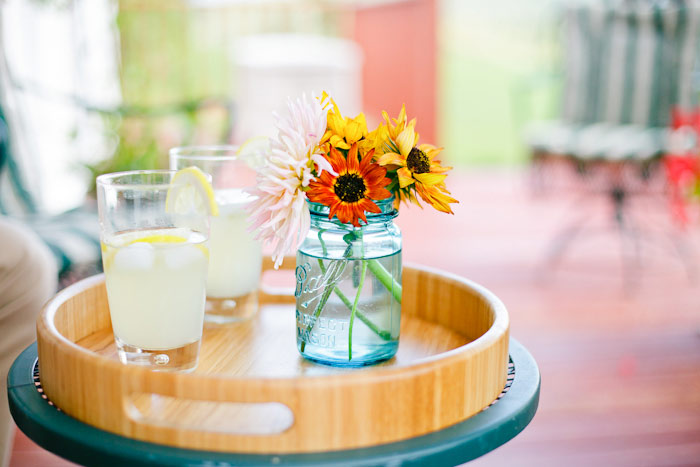 enjoying lemonade on porch under a vine summer engagement session shot on Fuji 400H