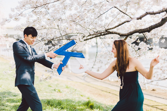 couple kissing in the cherry blossoms in Washington DC on the Tidal Basin