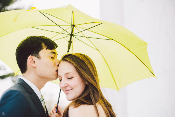 couple kissing in the cherry blossoms in Washington DC on the Tidal Basin