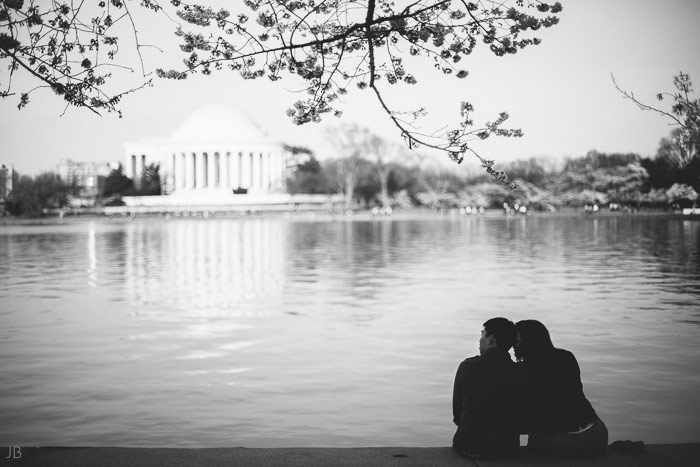 couple kissing in the cherry blossoms in Washington DC on the Tidal Basin