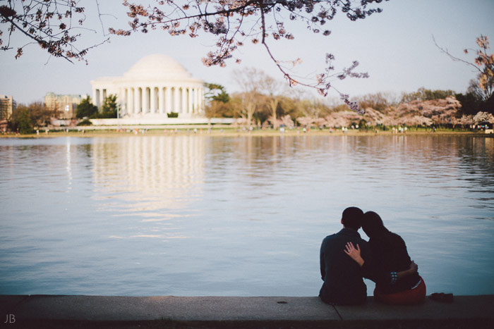 couple kissing in the cherry blossoms in Washington DC on the Tidal Basin