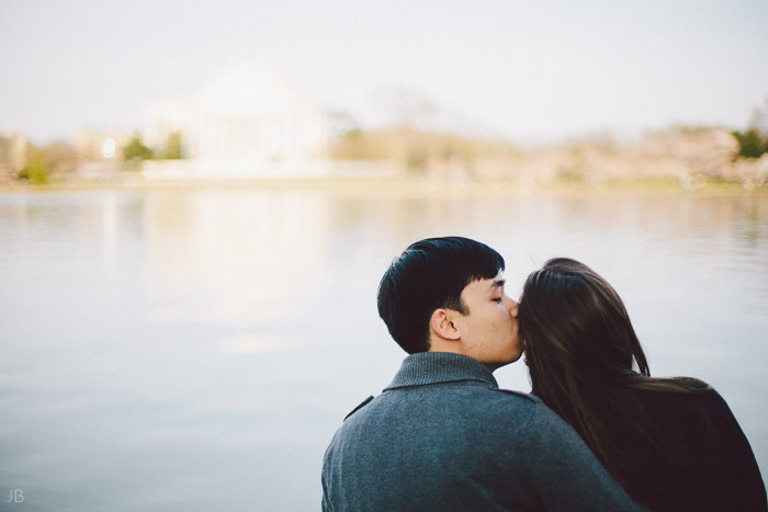 couple kissing in the cherry blossoms in Washington DC on the Tidal Basin