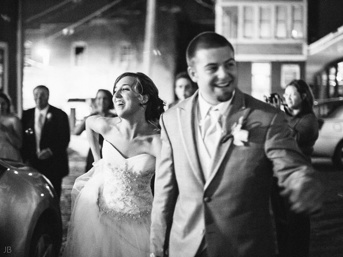 happy couple leaves their wedding in black and white