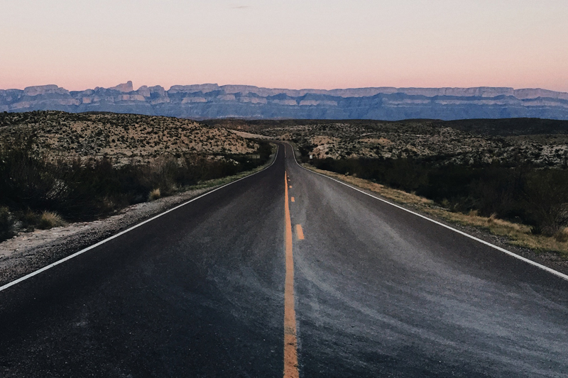 the main road going through big bend on the way to rio grand village campground at dusk - texas