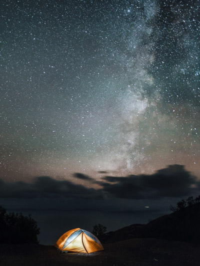 camping under the milky way on the pacific ocean in big sur california