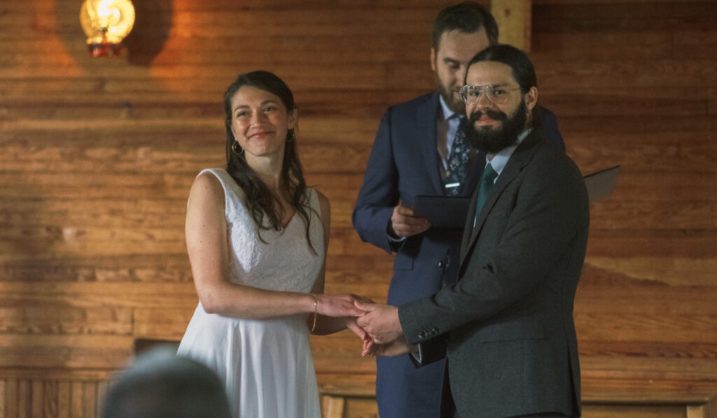 bride and groom smiling at crowd at Haines chapel