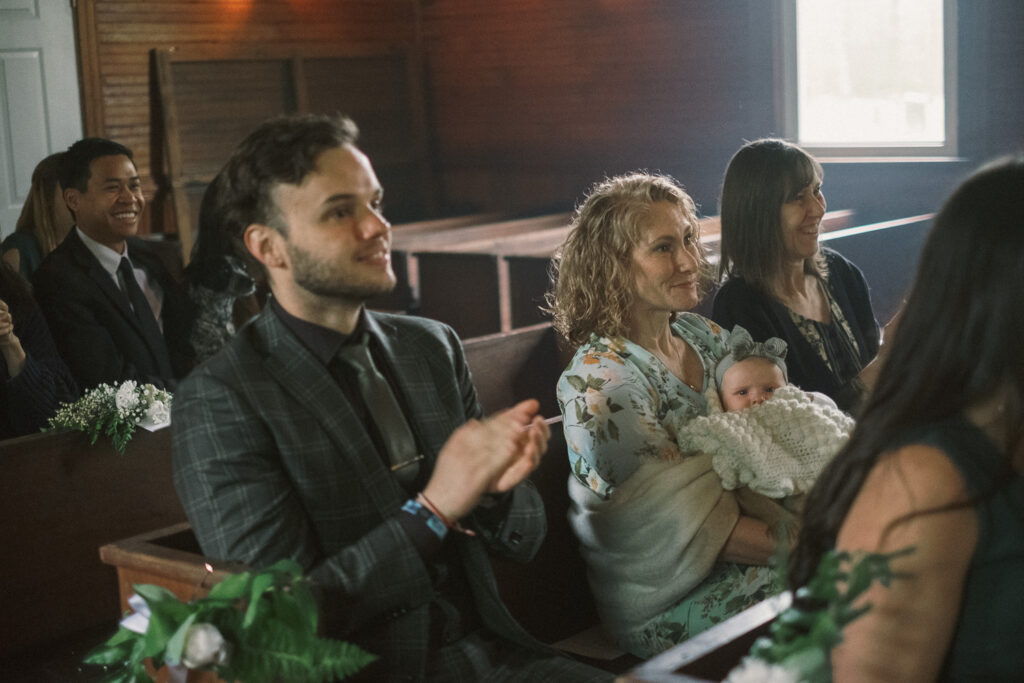 guests applauding at a wedding at Haines chapel - authentic documentary style photography