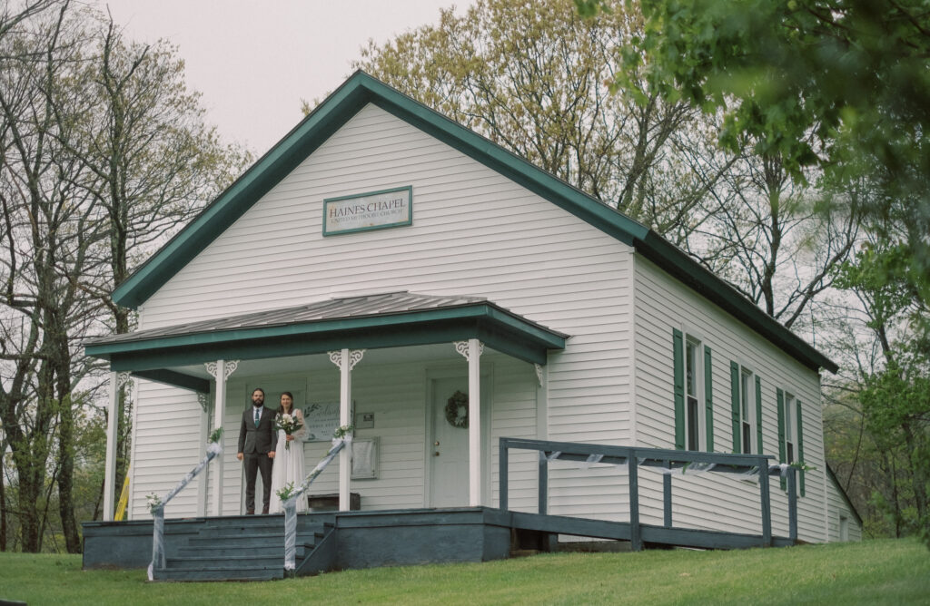 couple stands on steps at Haines Chapel, Virginia after wedding ceremony