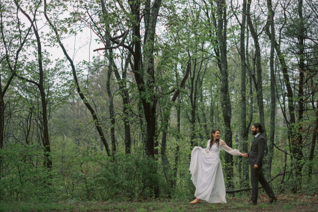 bride and groom walking along the woods  - natural edit