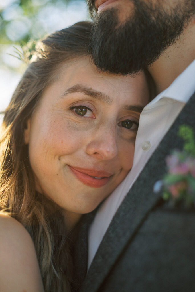 bride resting head on grooms shoulder - natural edit