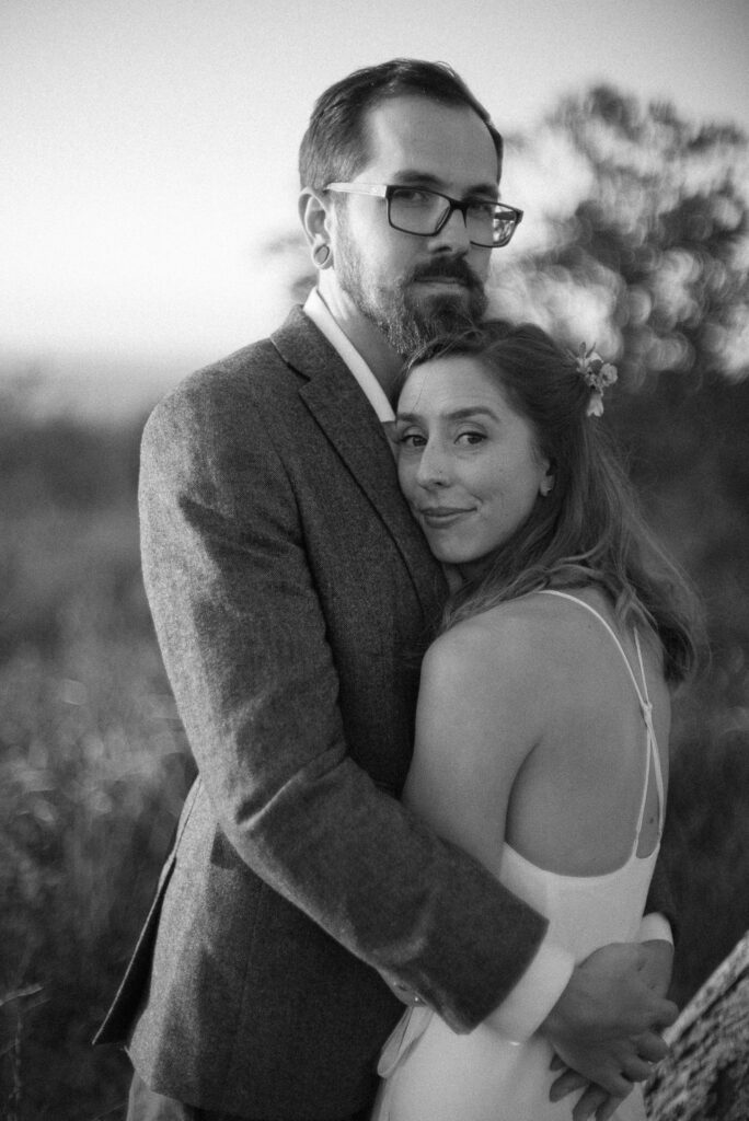 Black and white portrait of bride and groom hugging - Shenandoah National Park elopement - Ilford HP5+ - film based edit