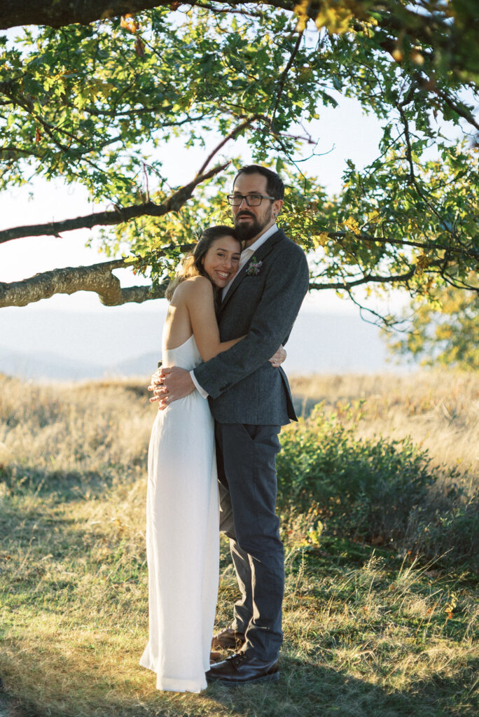 Bride and groom hugging under tree - Shenandoah National Park elopement - fuji400h - film based wedding photographer