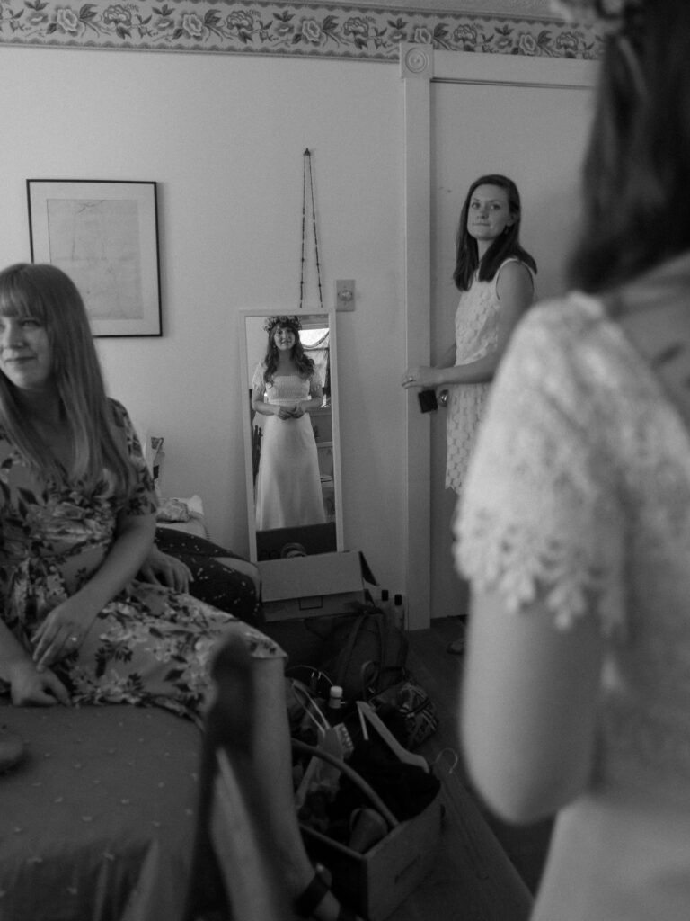 bride getting ready looking in mirror in farmhouse in Virginia - Ilford HP5+ black and white film look