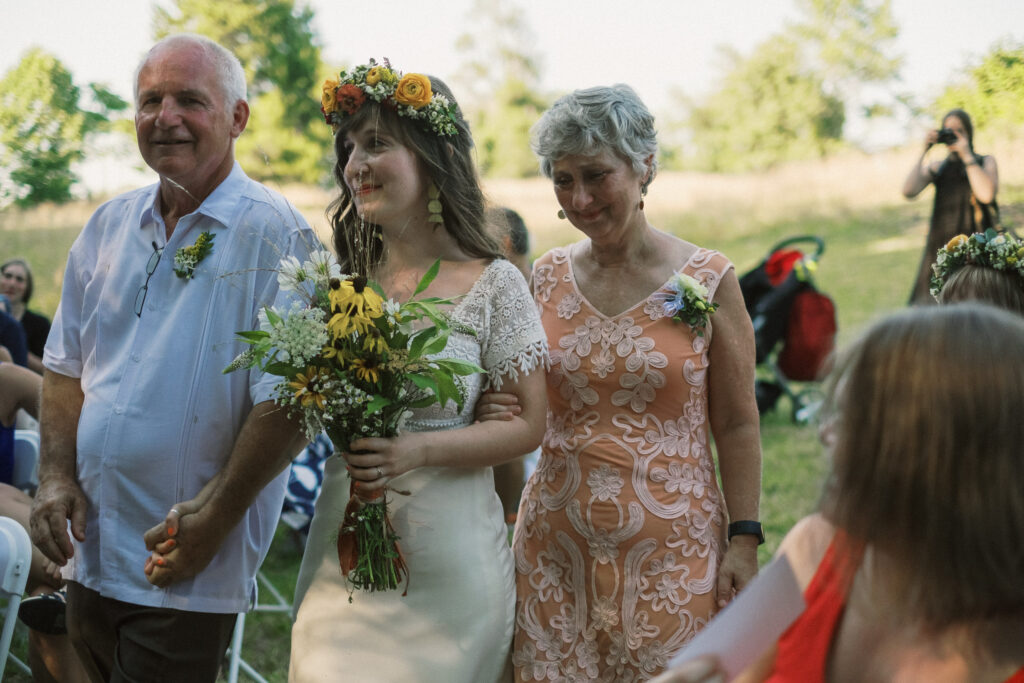 bride walking down aisle at outdoor wedding ceremony - film look 160C Virginia documentary wedding photographer