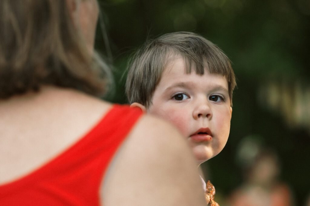 child at outdoor wedding ceremony - film look 160C Virginia documentary wedding photographer