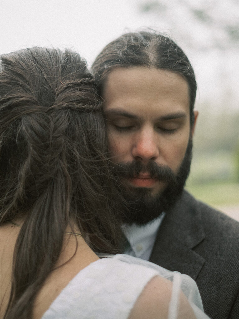 bride and groom hugging with eyes closed on rainy day - natural edit - natural skintones - fuji400h