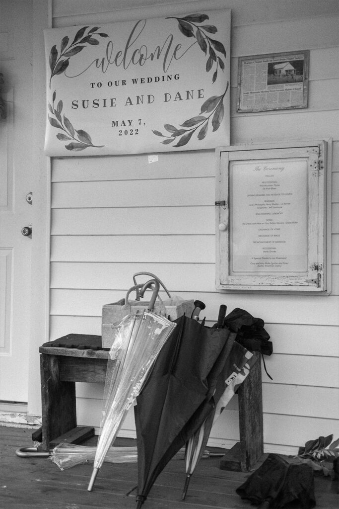 umbrellas and a wedding sign outside Haines chapel, Virginia - Ilford HP5+ - authentic documentary style photography