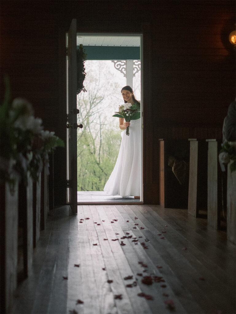 bride peeking through doorway, about to enter ceremony at Haines chapel, Virginia