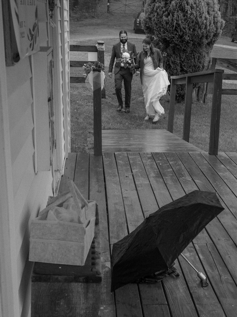 black and white photograph of bride and groom entering Haines chapel on overcast day - documentary style photography - Ilford HP5+