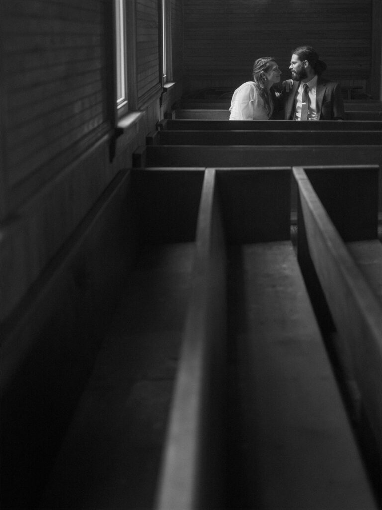 black and white photograph of bride and groom inside Haines chapel - environmental portrait