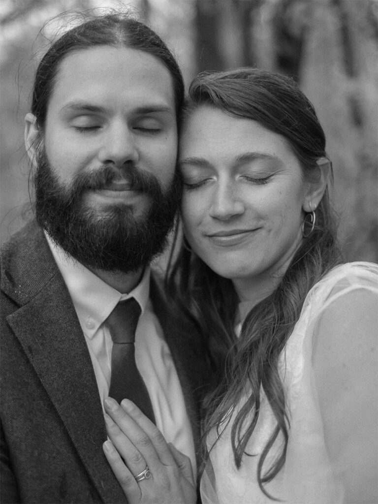 black and white photograph of bride and groom portrait with eyes closed - Ilford HP5+