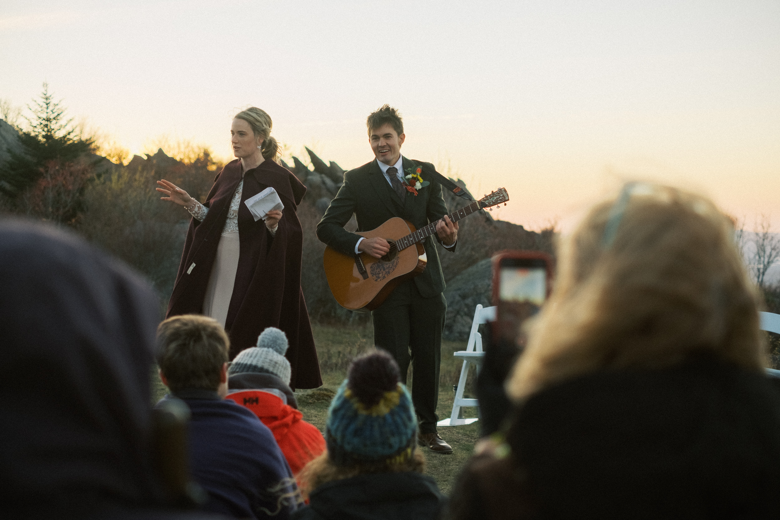 bride and groom play guitar for their own sunrise wedding ceremony at the Grayson Highlands - captured by Virginia documentary wedding photographer - fujifilm classic wedding photo