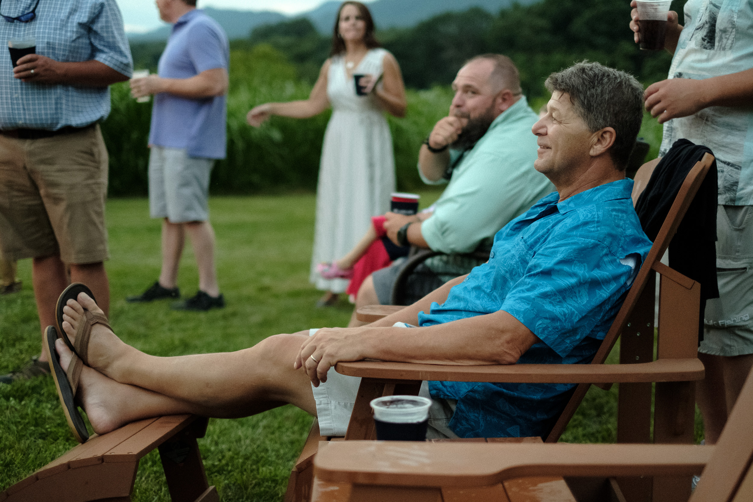 documentary wedding photography wedding guest relaxing in lawn chair - Virginia documentary wedding photographer - fly on the wall style photography