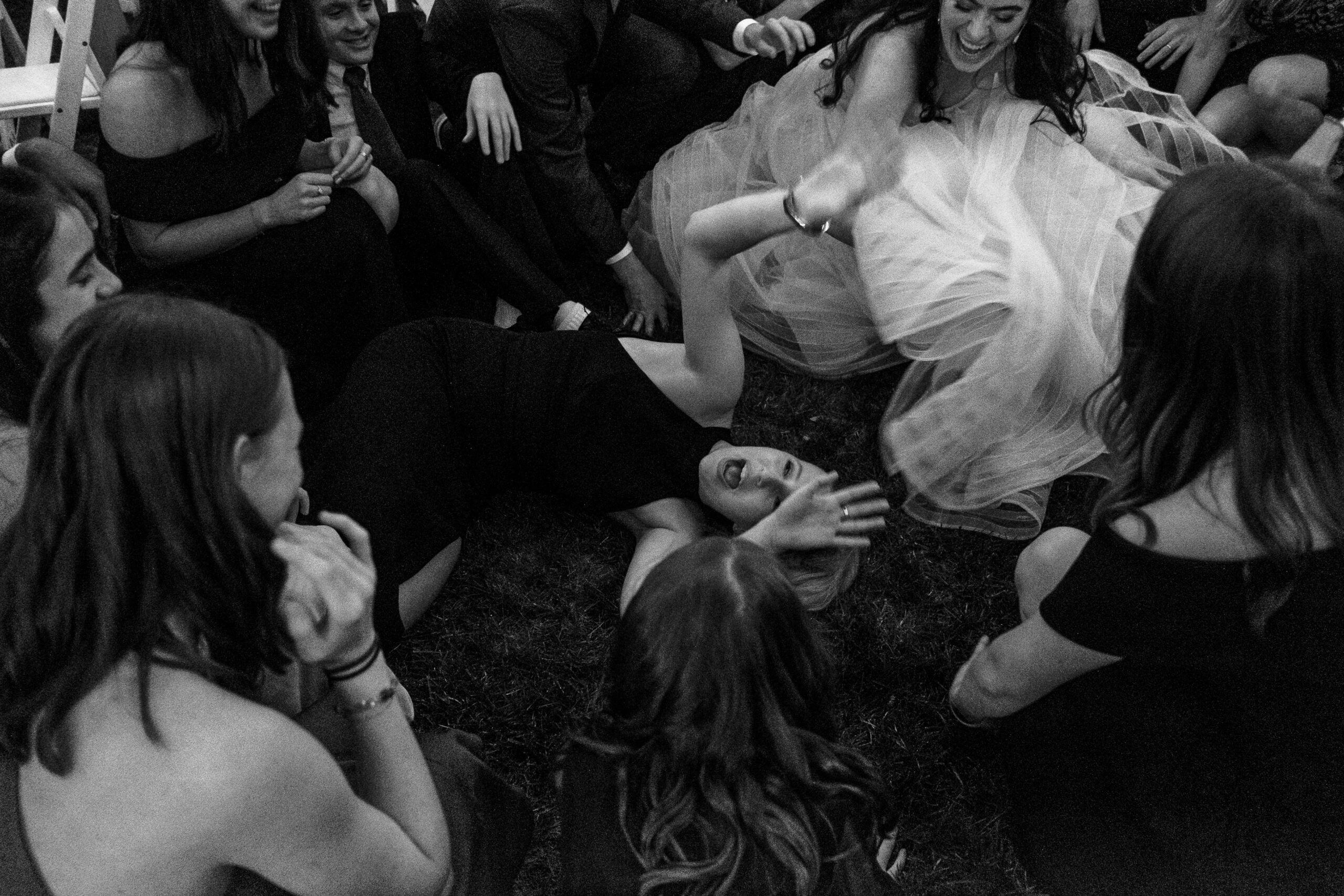 wedding party and bride dancing in black and white - documentary style wedding photographer