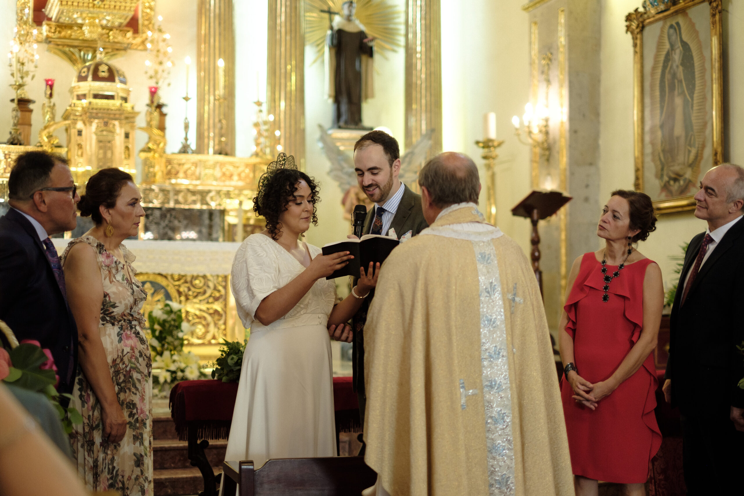 catholic Bride and groom reading vows surrounded by family during their ceremony in Guadalajara Mexico - captured by documentary wedding photographer - fujifilm classic wedding photo