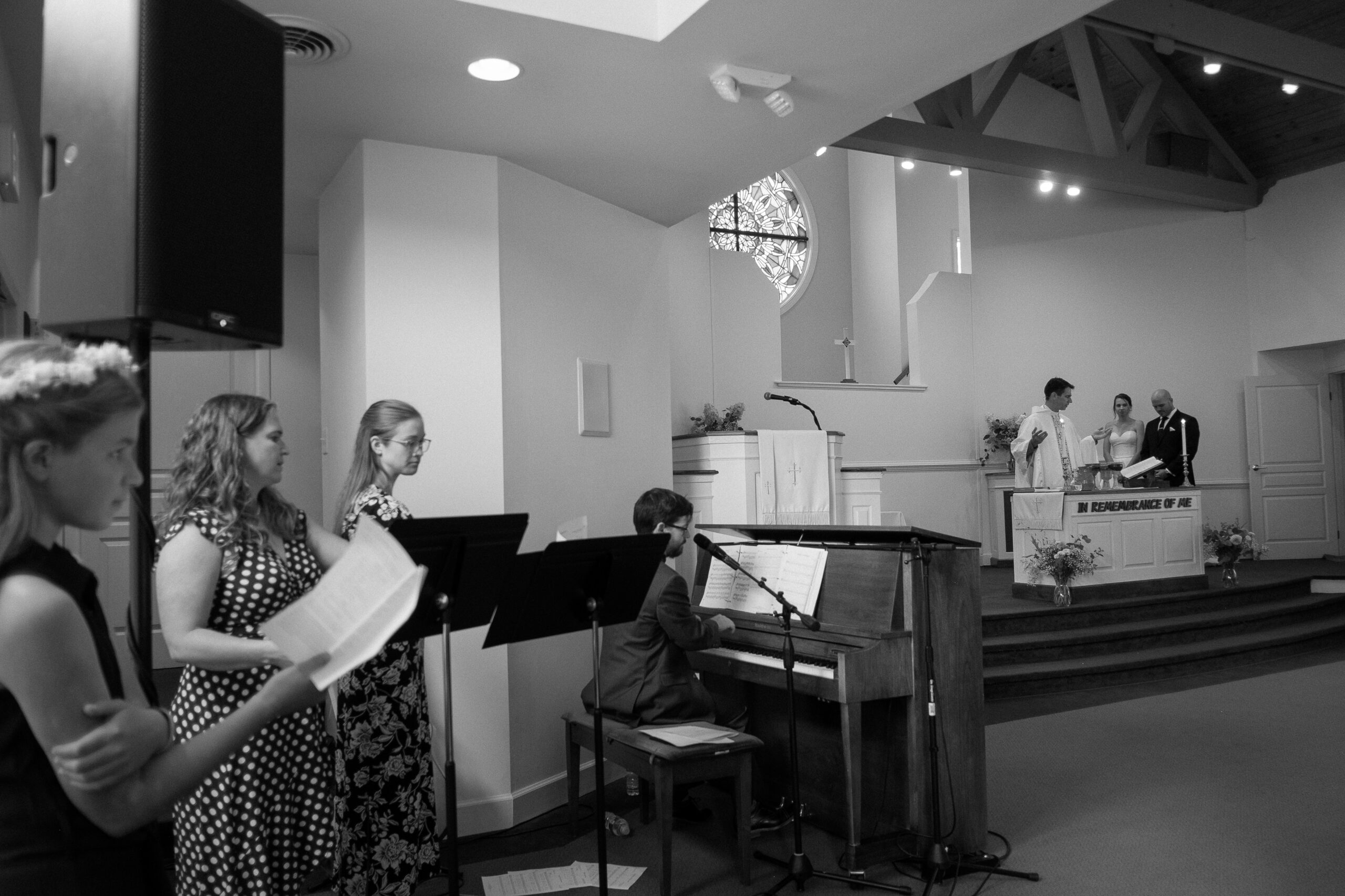 wide angle documentary wedding photo in black and white taken at church of the incarnation in richmond virginia